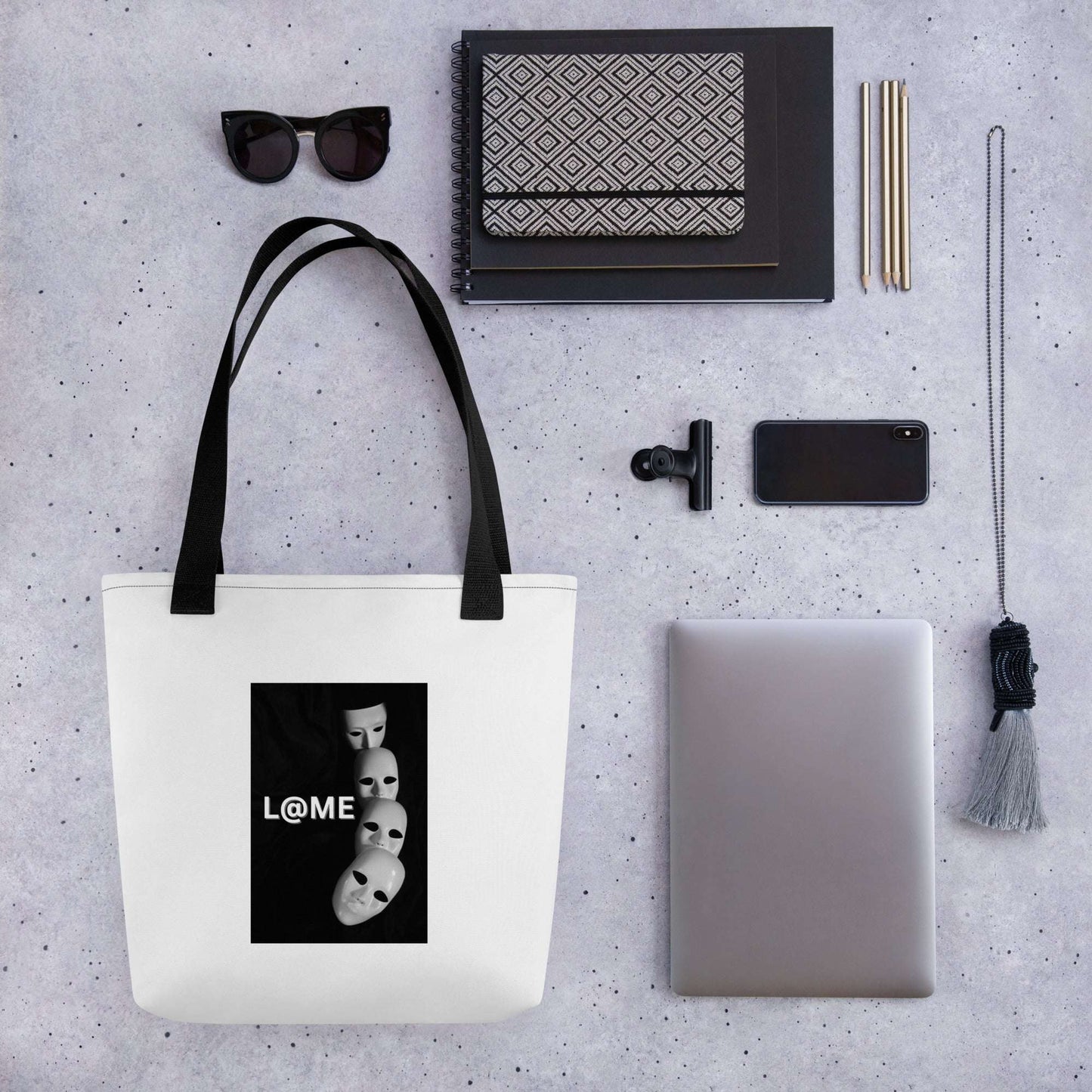 A spacious tote bag featuring a colorful falling masks design and dual cotton handles.