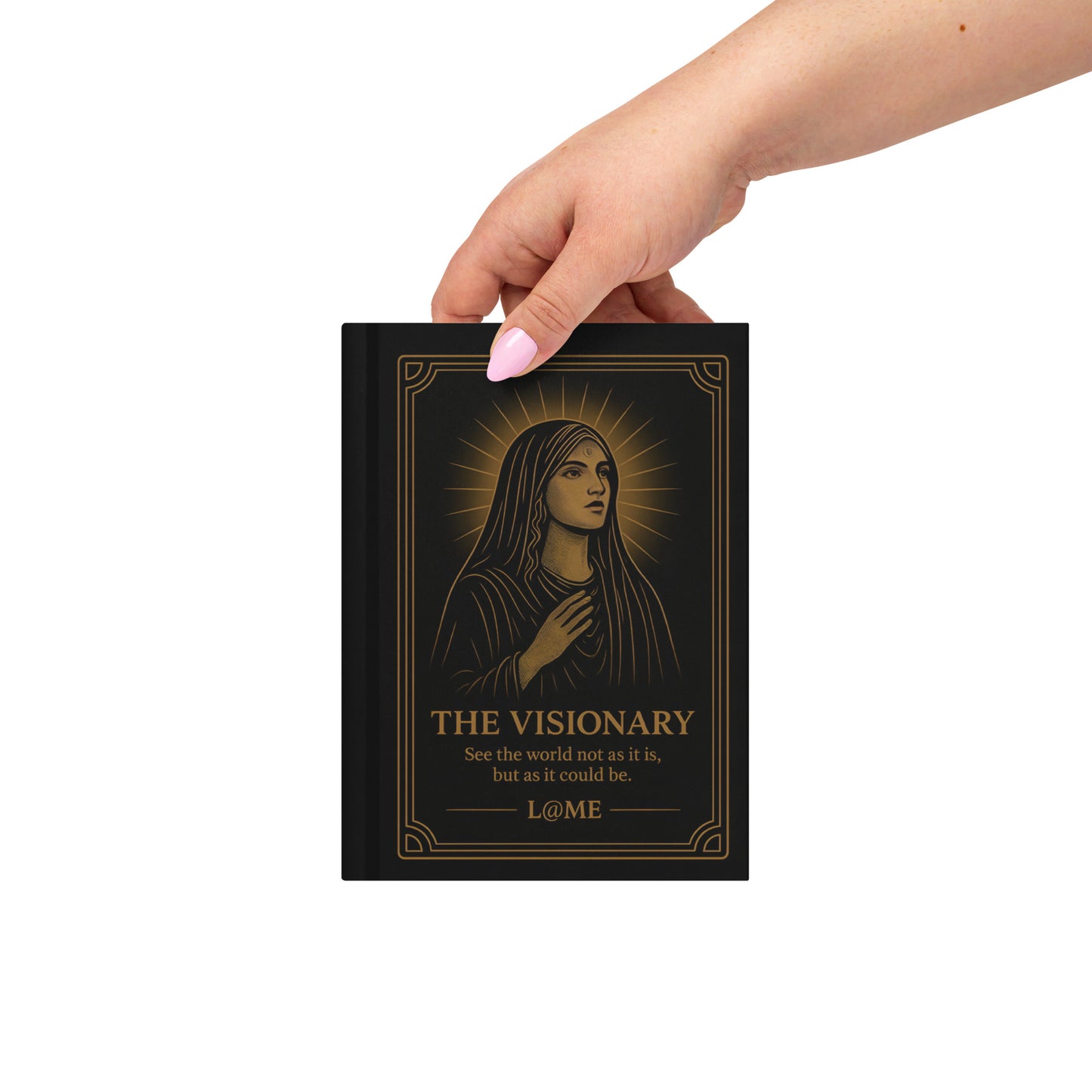 A matte hardcover journal with gold tarot-style artwork on a deep black cover.