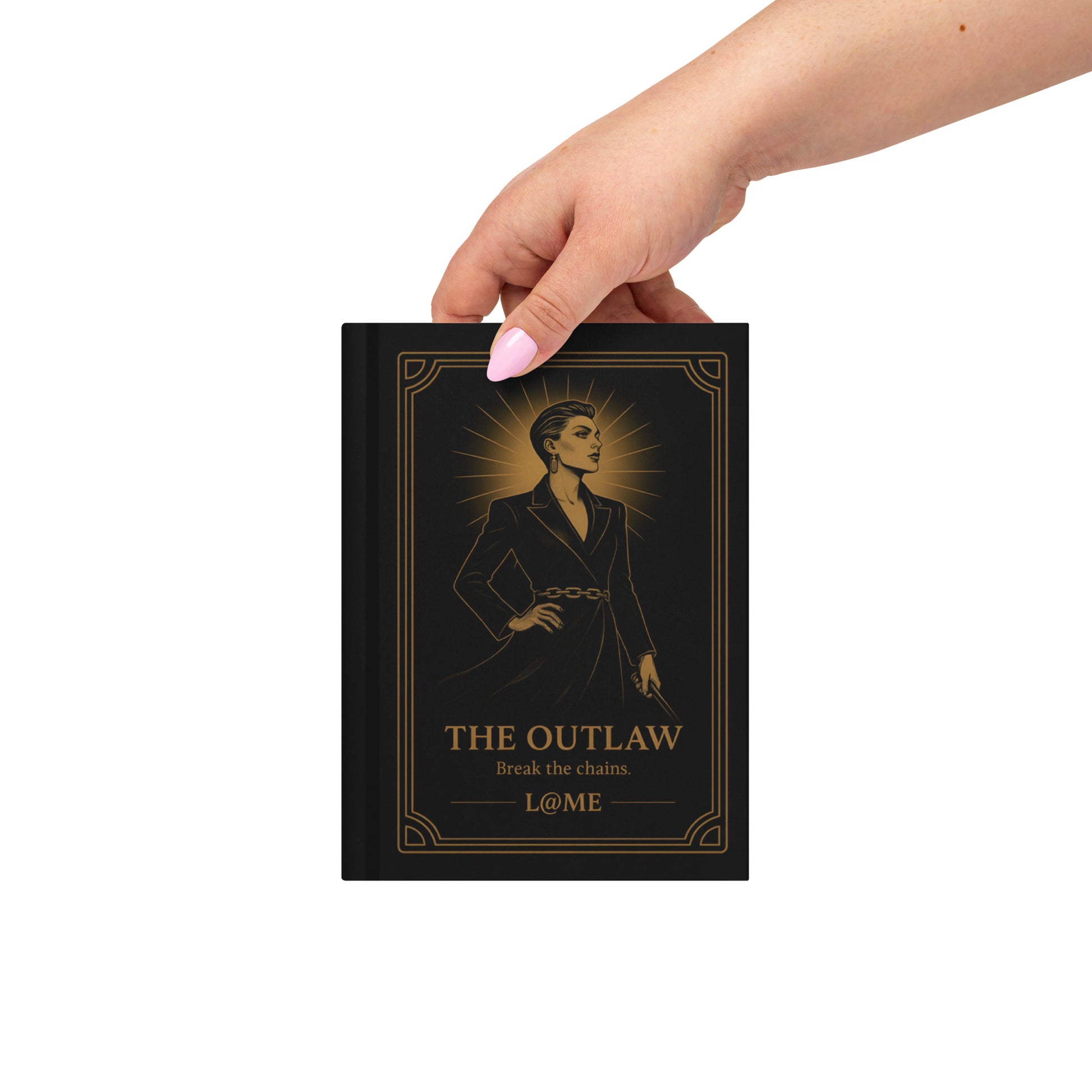 A matte hardcover journal with gold "Outlaw" artwork on a deep black cover and lined pages.