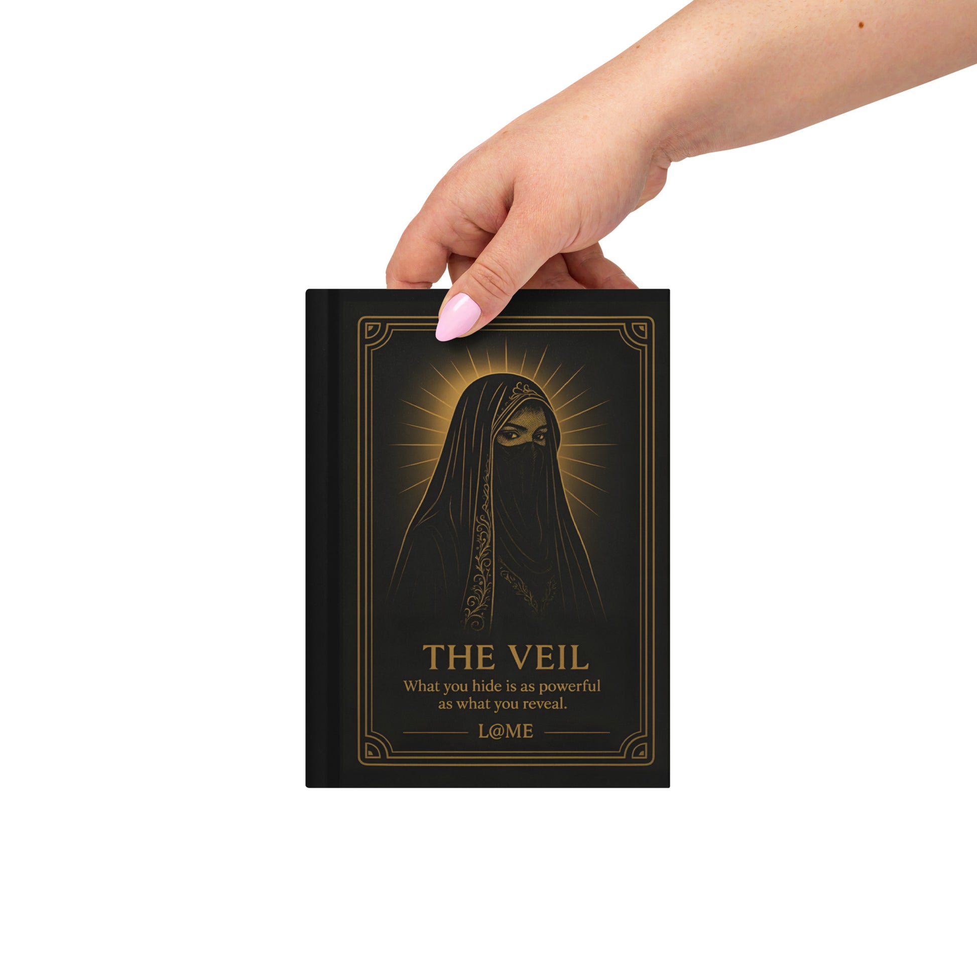 A matte hardcover journal with gold "Veil" artwork on a deep black cover and lined pages.