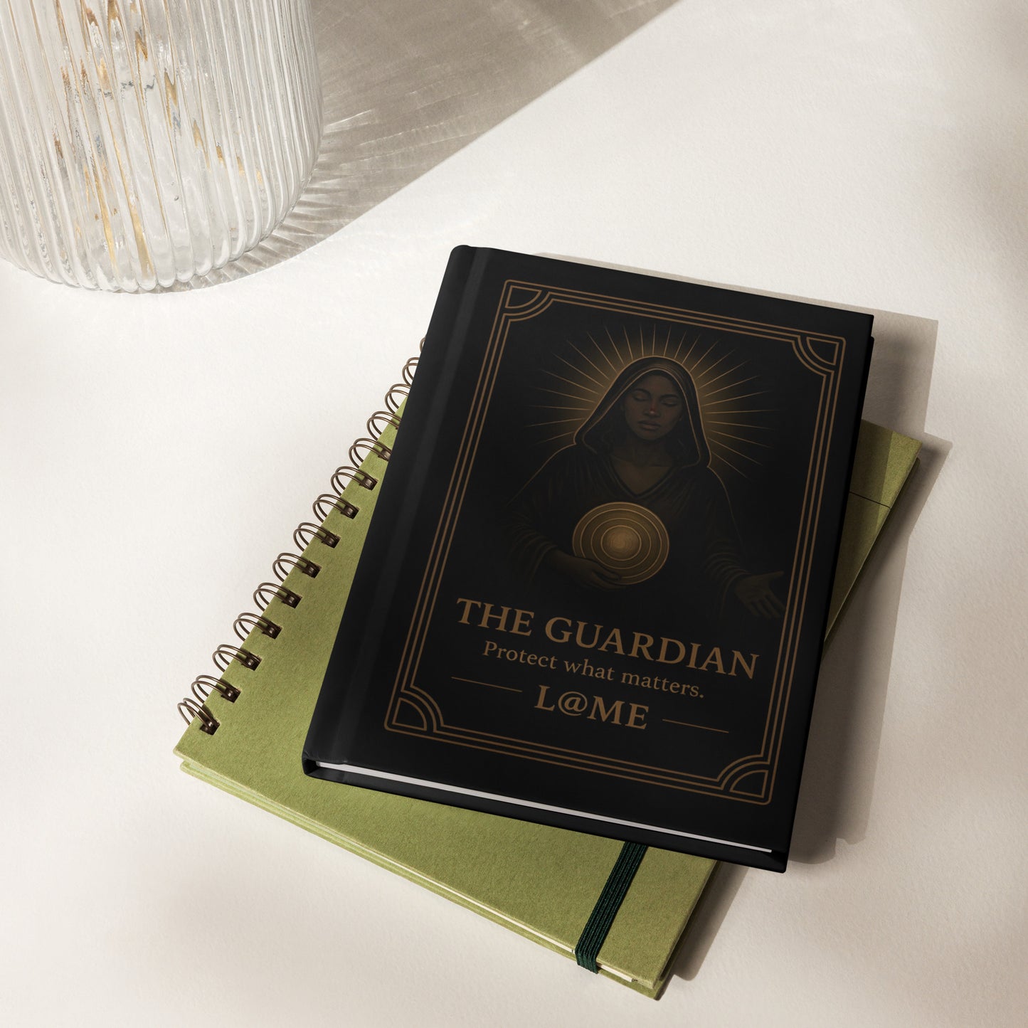 Matte black hardcover journal with gold Guardian tarot-style artwork and lined pages.