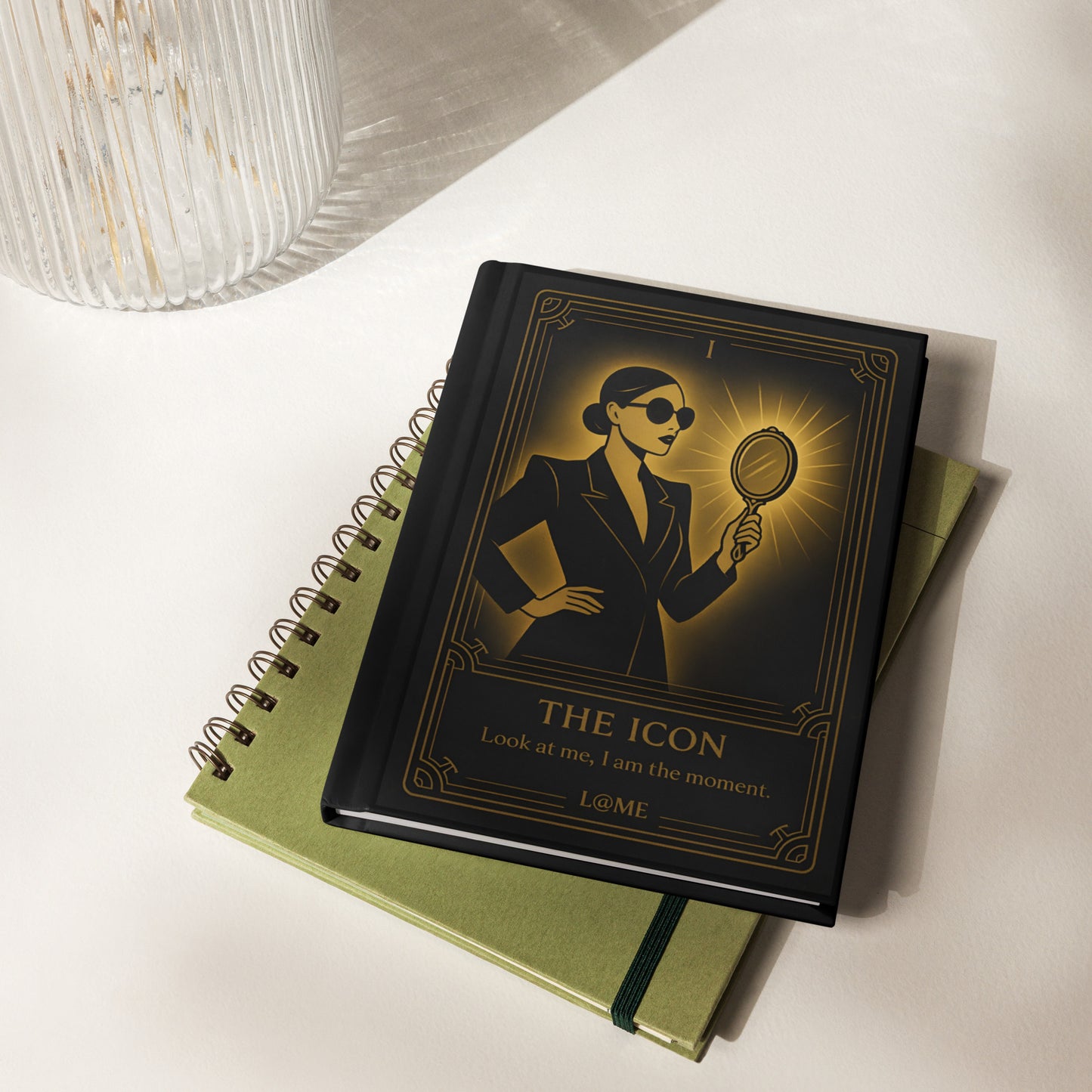 Matte black hardcover journal with gold tarot-style artwork and lined perforated pages.