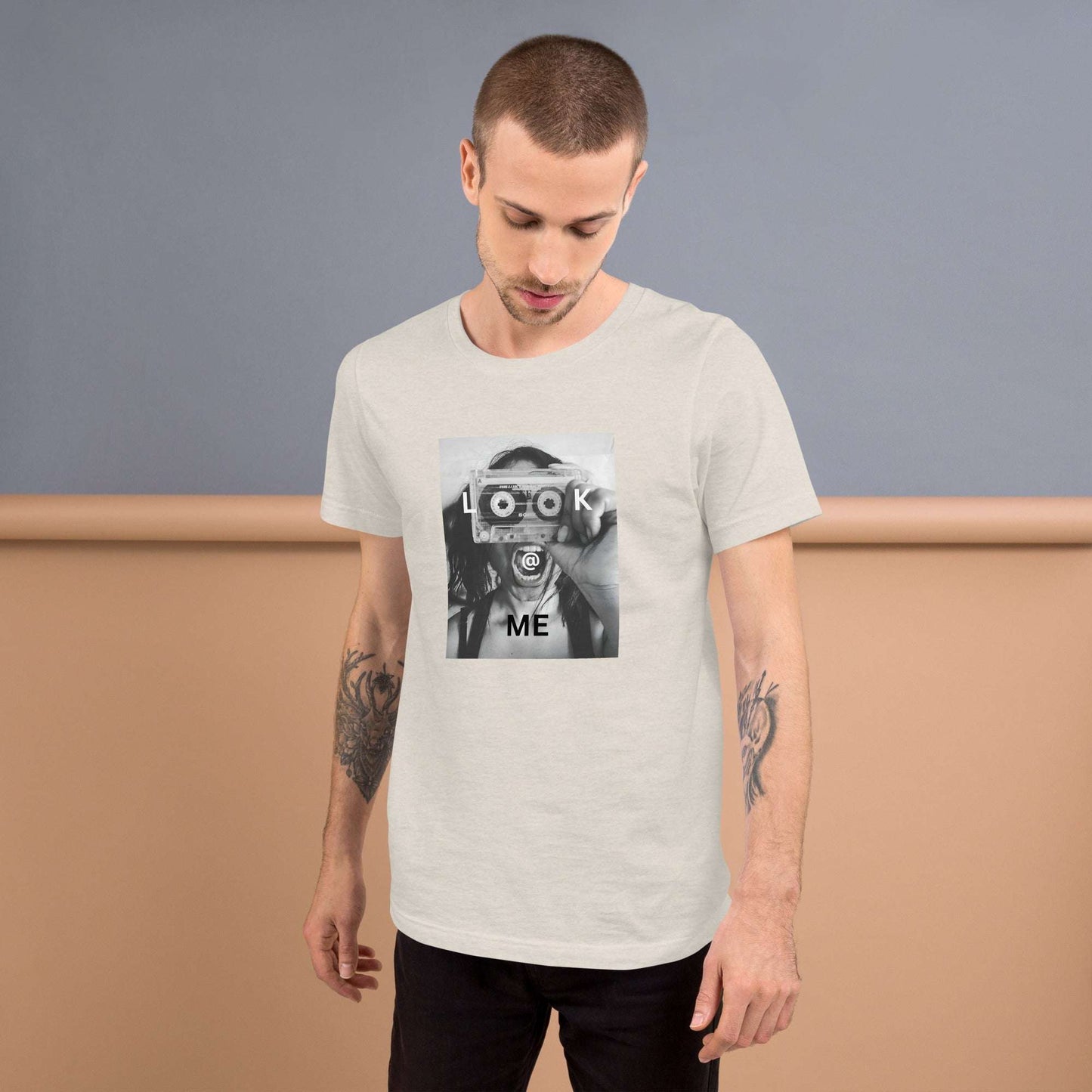 Black and white tee with a woman holding a cassette like a camera printed on front