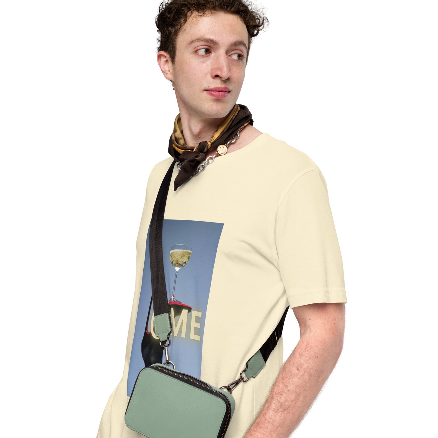 Black stiletto balancing a golden coupe glass on a unisex t-shirt.